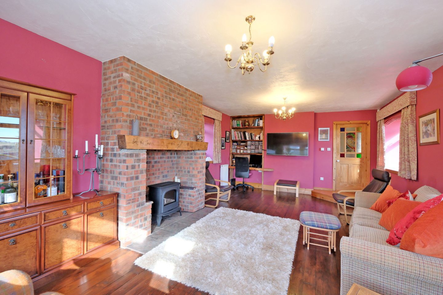 Lounge area inside the Newmachar steading renovation featuring large brick fireplace.