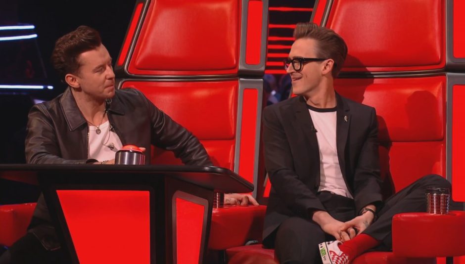 Danny Jones and Tom Fletcher on the Voice, sitting on a red judges chair.