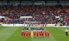 Aberdeen and Dundee during the minute's applause in memory of Fabian Caballero. Image: Shutterstock.