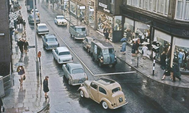 St Nicholas Street as it was in 1923, left, and in the 2000s, right, surrounded by P&J headlines about its redevelopment. Image: DC Thomson/Roddie Reid