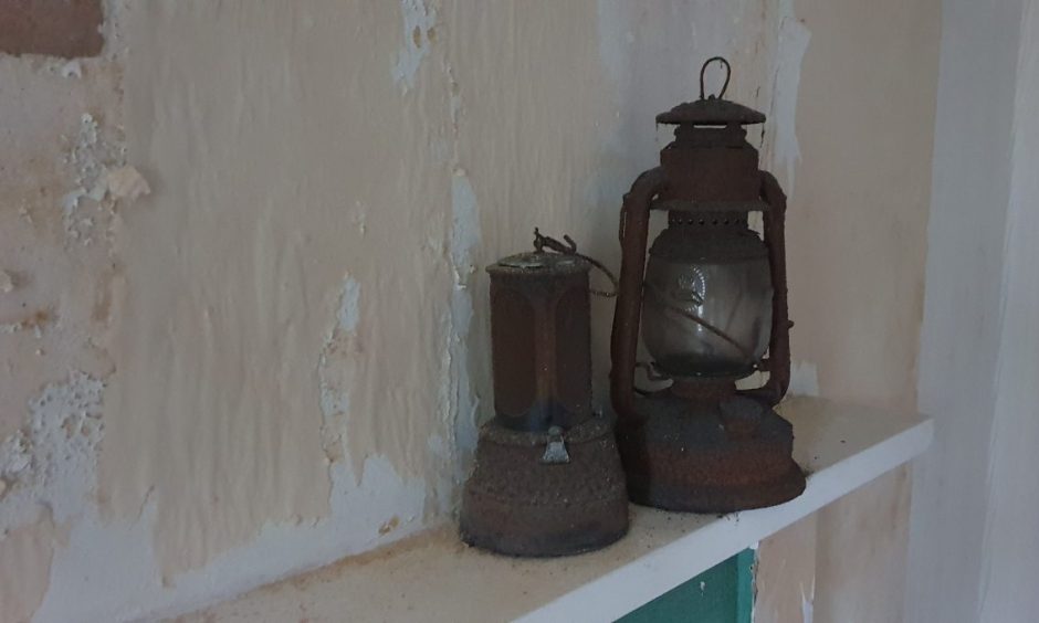 Old lantern and torch on fireplace 