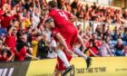 Aberdeen FC's Kevin Nisbet celebrates with Graeme Shinnie in front of fans after scoring to make it 1-0 against Ross County