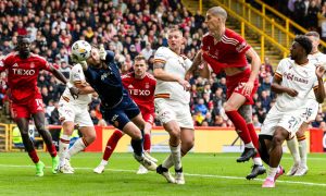 Motherwell's Aston Oxborough makes a save under pressure from Aberdeen's Slobodan Rubezic. Image: SNS.