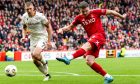 Aberdeen's Kevin Nisbet has a shot as Motherwell's Liam Gordon watches on. Image: SNS