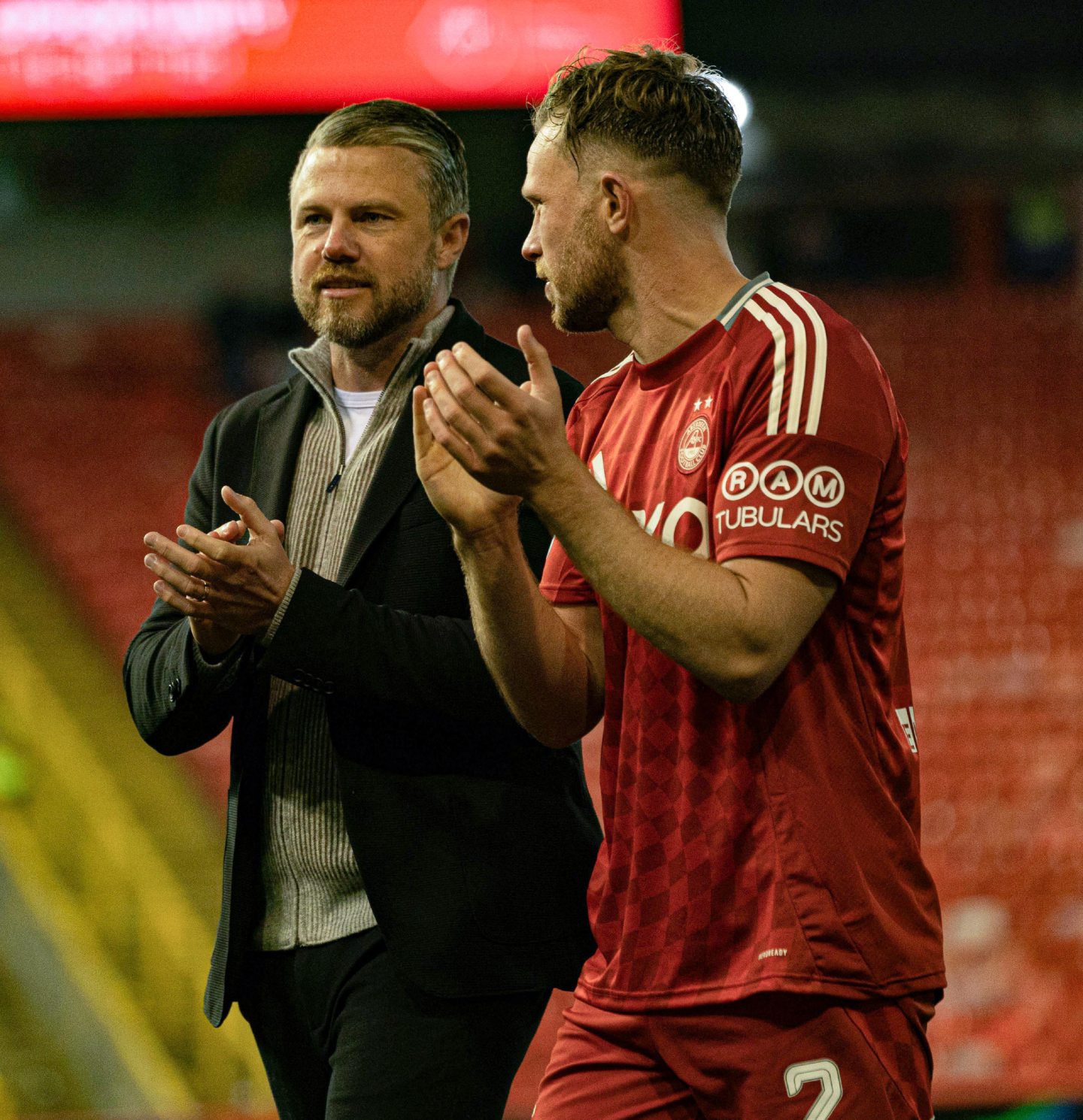 Aberdeen's Nicky Devlin with manager Jimmy Thelin at full-time in the 4-0 Premier Sports Cup win against Spartans. Image: SNS