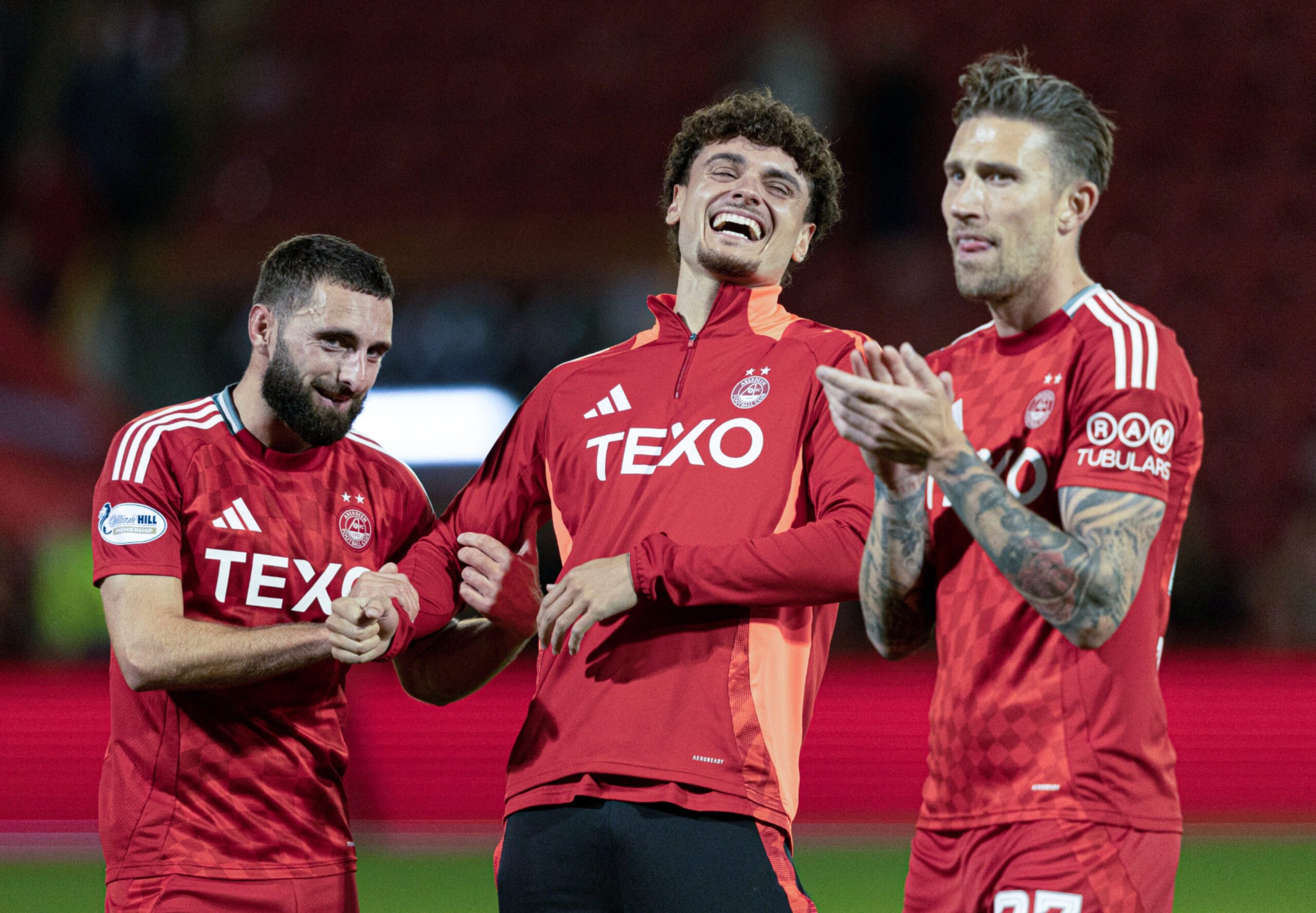 Aberdeen's Graeme Shinnie, Dante Polvara, and Angus MacDonald at full time after the 4-0 win against Spartans. Image: SNS 