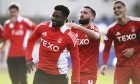 Aberdeen attacker Duk is pushed towards the club's travelling support by captain Graeme Shinnie after the 2=1 win against Dundee. Image: SNS