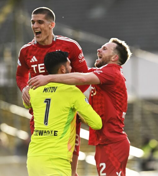 Aberdeen's Dimitar Mitov, Nicky Devlin and Slobodan Rubezic celebrate at full-time after winning 2-1 against Dundee.