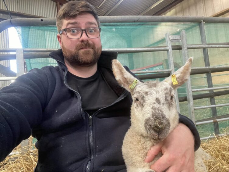 Greig Bain with a sheep.