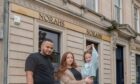 Nathan Davies, his partner Ashlyn and his daughter Norah outside their new business.