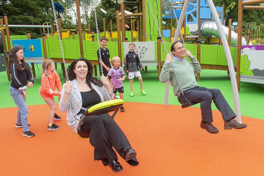 Education and children's services convener Martin Greig and vice-convener Jessica Mennie were among the first to test drive the swings at the new Hazlehead playpark. Image: Aberdeen City Council