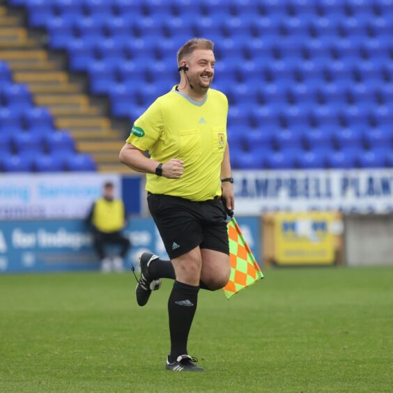 ICTFC supporter Jamie MacKinnon steps in as linesman, following an injury to referee Stewart Luke. 