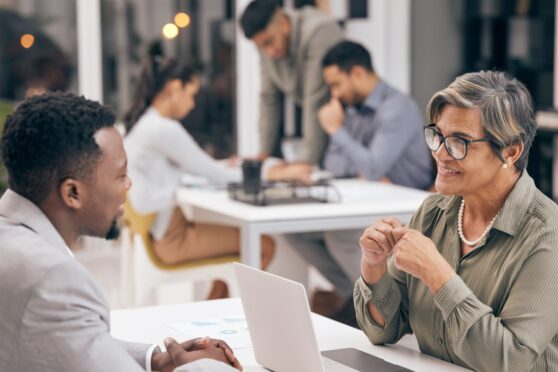 man speaking to mature HR manager for hiring opportunity