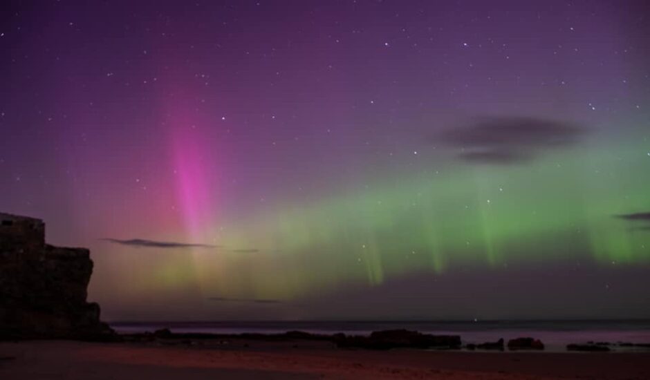 Pink and green sky above Covesea Beach