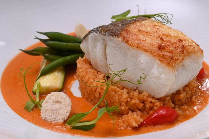 The cod surrounded by an orange rouille