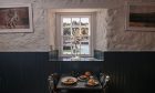 A table at the Tolbooth Seafood Restaurant by a window in Stonehaven