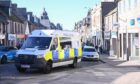 Police locked down Peterhead's Queen Street. Image: Darrell Benns/DC Thomson