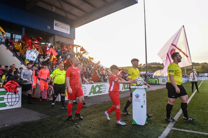 Alex and Mike Bradford walking on the pitch ahead of the match. Image: Darrell Benns/DC Thomson