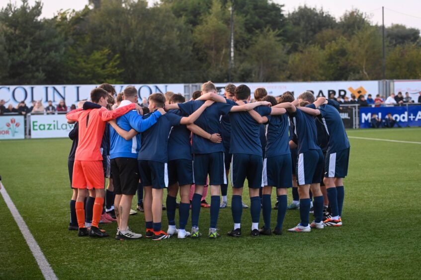 Pictured are Cove Youth in a huddle before kick off. Image by Darrell Benns/DC Thomson