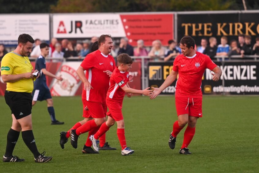 Aberdeen players Darren Mackie and Derek Young with Alex Bradford after a goal to make it 1-1.