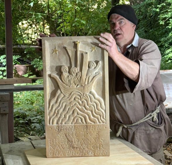 Sculptor Philip Chatfield with carving of St Brendan 