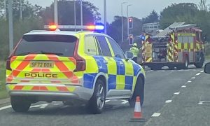 firefighters and police attend car on fire