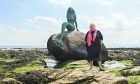 Maureen Ross has a deep love of the Easter Ross Seaboard Villages. Pictured here with the mermaid of Balintore. Image: Jason Hedges/DCT