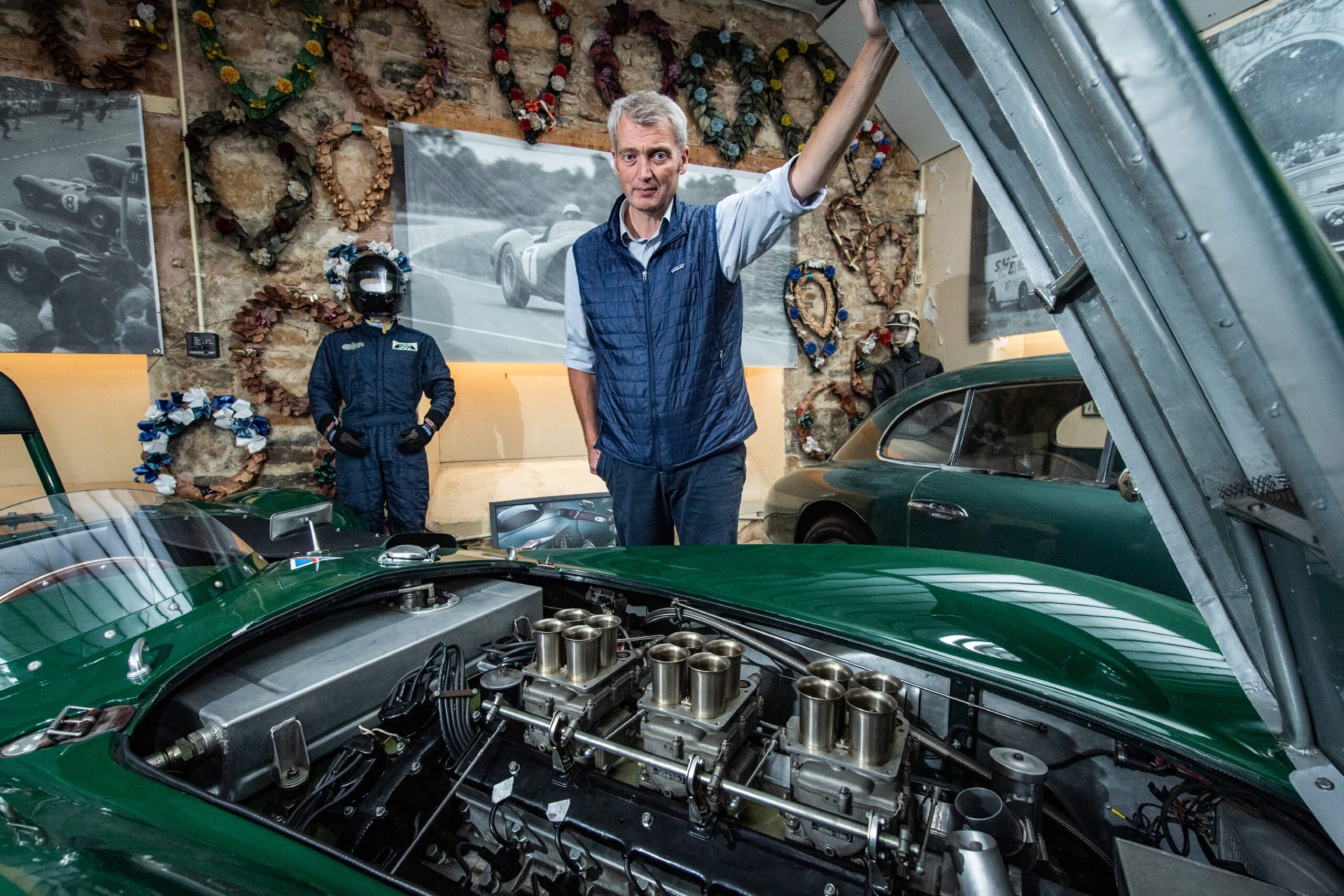 Darren holding open the bonnet of the Lagonda, revealing the clean engine inside.