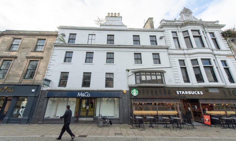 Exterior of Starbucks and M&Co on Elgin High Street. 