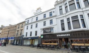 Exterior of Starbucks and M&Co on Elgin High Street.