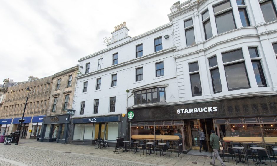 Exterior of Starbucks and M&Co on Elgin High Street. 