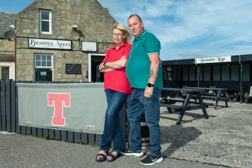 Lynn and Alan Mitchell standing outside the Brander Arms pub in Lossiemouth