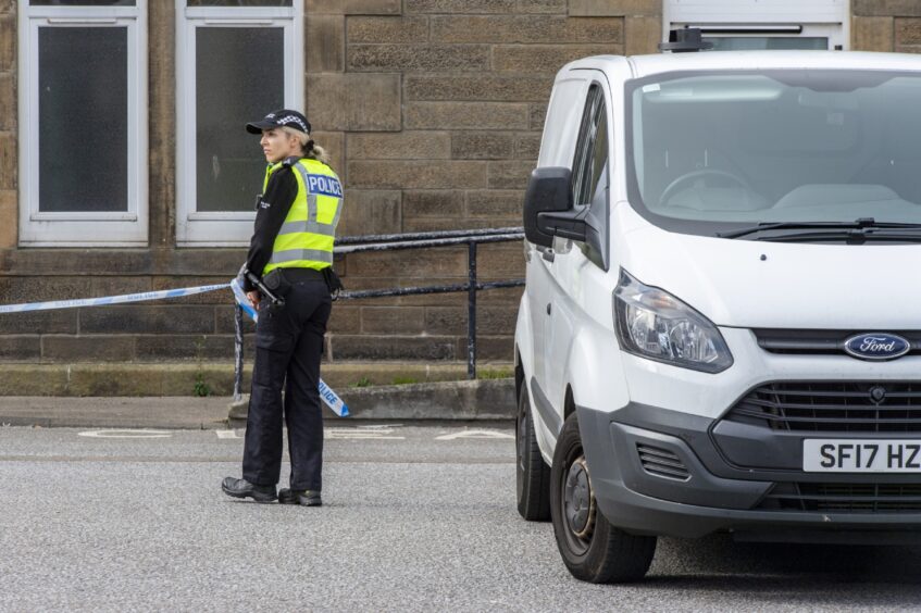 Police officer next to van in Cluny Square 