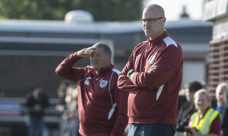 Keith manager Craig Ewen standing on the touchline during a game