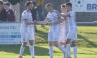 Aidan Wilson, second from left, is congratulated by his Inverurie Locos team-mates after scoring their third goal against Keith. Pictures by Jason Hedges/DCT Media.