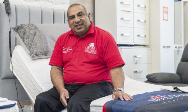 Zafar Ali sitting on bed.