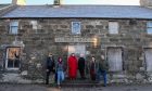 Members of Clan Baird stood outside Dower Hotel in New Aberdour.