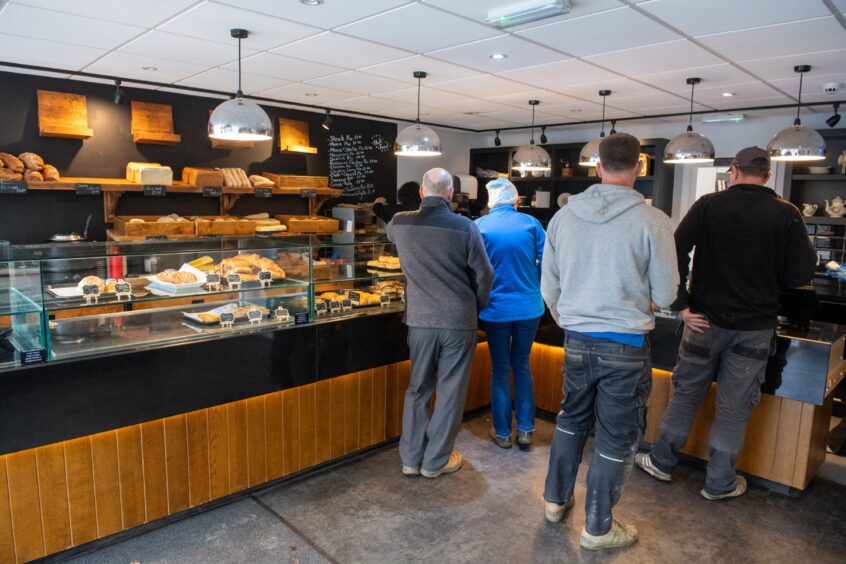 Customers waiting at bakery counter