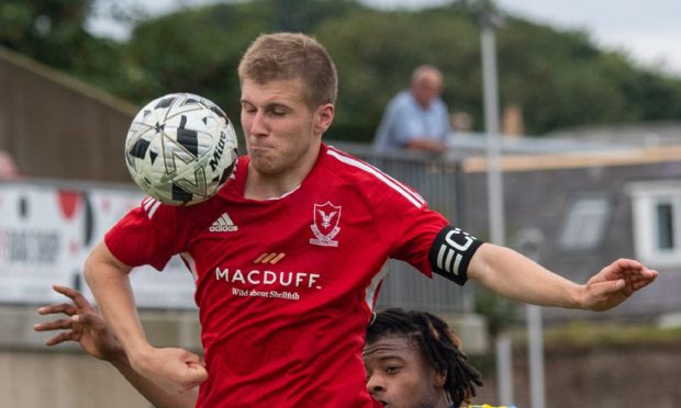 CR0049509
Highland League;
Deveronvale (red) v Strathspey Thistle at  Princess Royal Park, Banff.
Picture shows; Vale's Jamie MacLellan, left, and Strathspey's  Doeimassei Doguie
17/08/24   Picture by Kami Thomson/DC Thomson