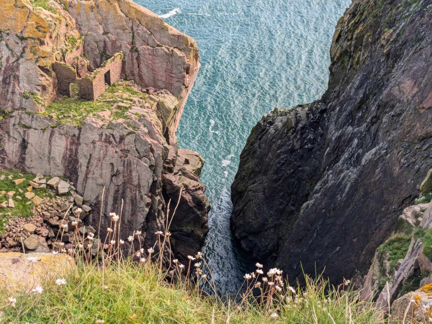 Stay away from the cliff edges if taking photos of the old quarry workers' bothy at Longhaven! Image: Gayle Ritchie.