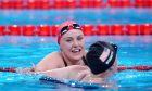 Faye Rogers (facing) celebrates gold in the women's 100m butterfly S10 final on day six of the Paris 2024 Paralympic Games. Image: PA.