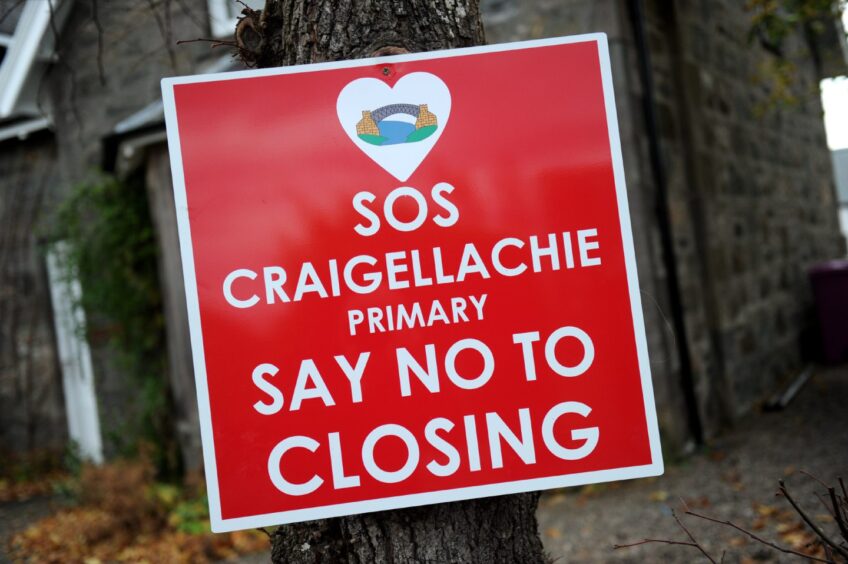 Sign reading "sos Craigeallachie primary, say no to closing". 