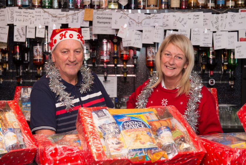 Alan and Lynn Mitchell with Christmas hampers