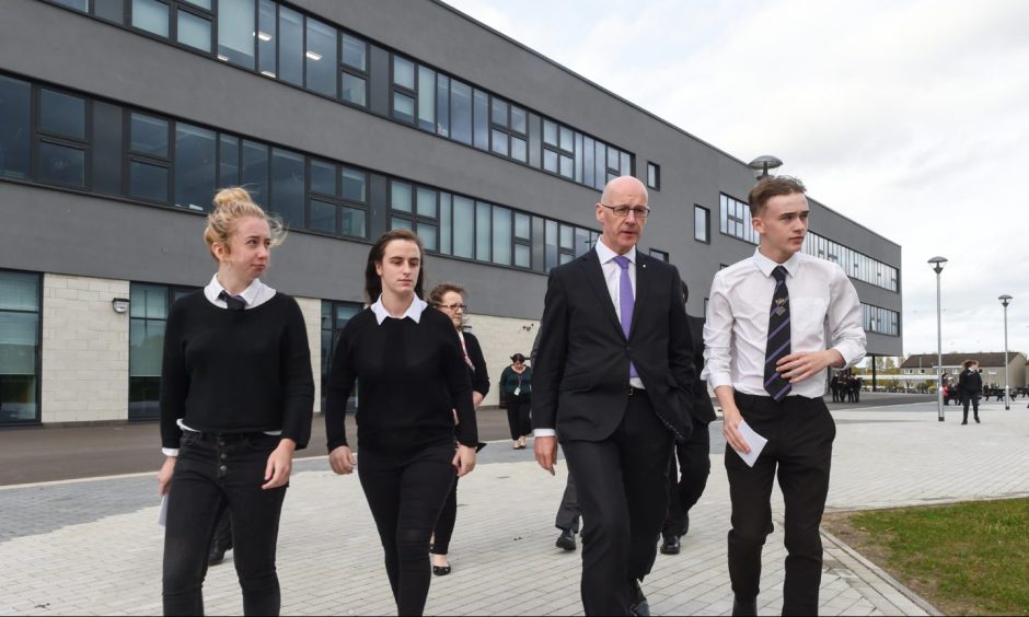 John Swinney outside Elgin High School with pupils. 