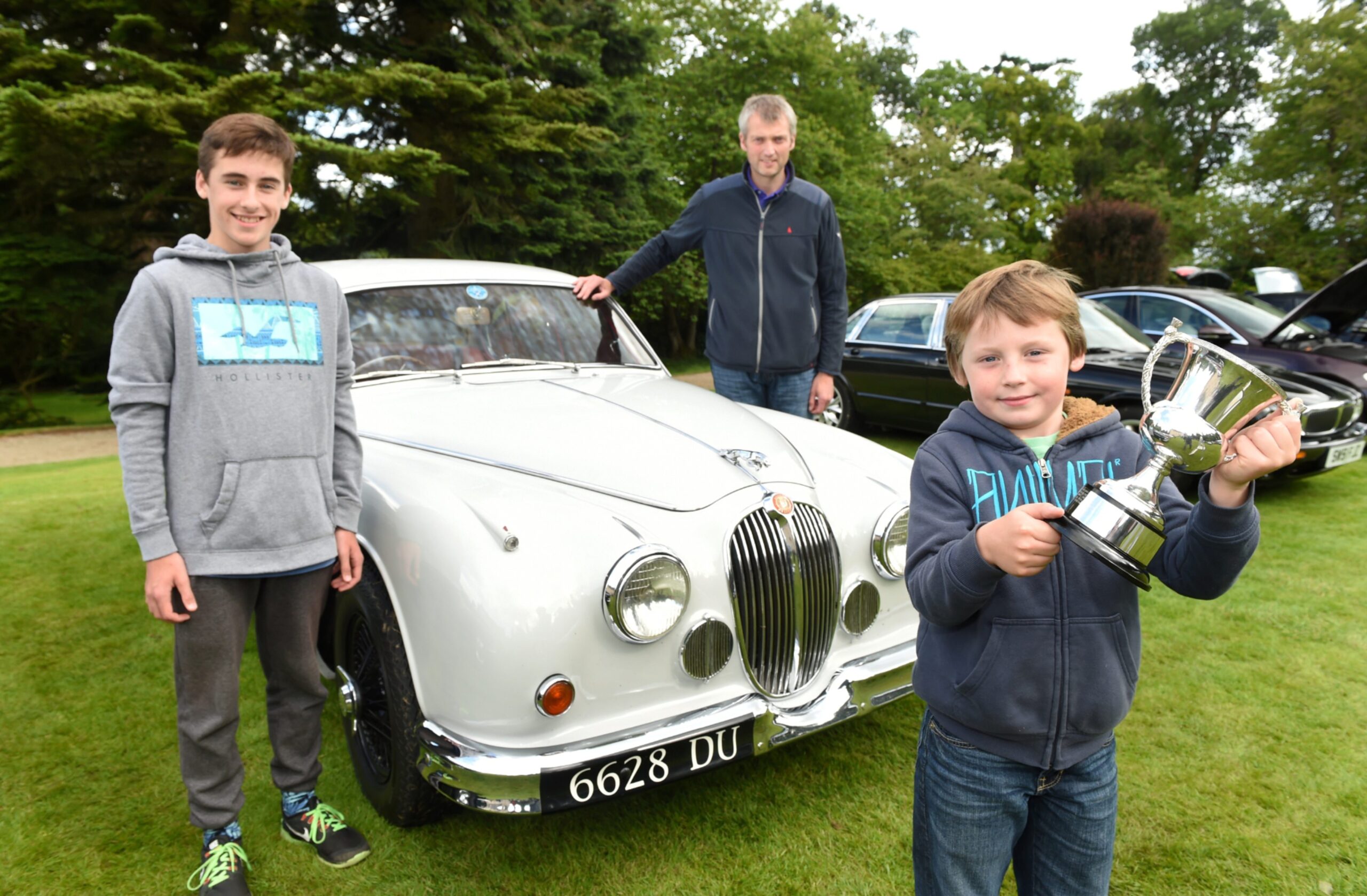 Darren, Bruce and Callum Mcwhirter in early days with their 1961 MkII Combe at the Jaguar Enthusiasts Club's annual gathering in Drum Castle. 