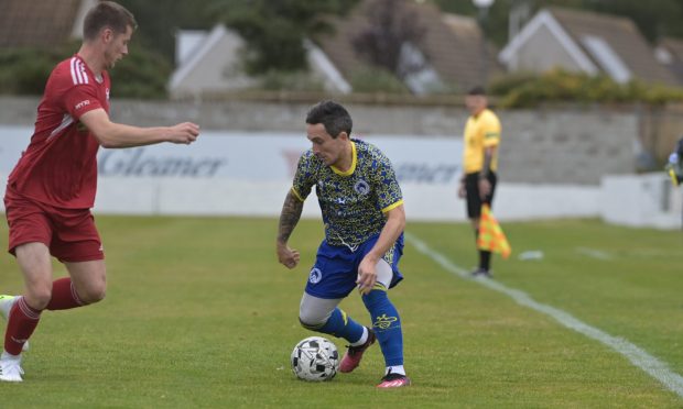 Lossiemouth v Nairn County at Grant Park in the Breedon Highland League on September 14 2024.

Nairn's Andrew Greig, right, runs at Lossiemouth's Brandon Hutcheson.

Pictures by Sandy McCook/DCT Media.