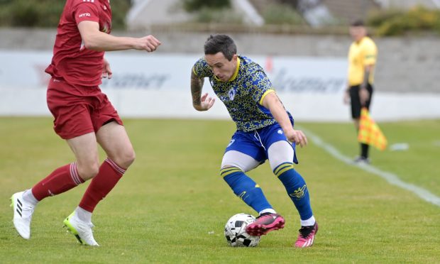 CR0049905
Callum Law,
Aberdeen.
Lossiemouth FC Vs Nairn County FC at Grant park, Lossiemouth.
Nairn County's Andrew Greig, right, runs at Lossiemouth's Brandon Hutcheson.
14th September '24
Sandy McCook/DC Thomson