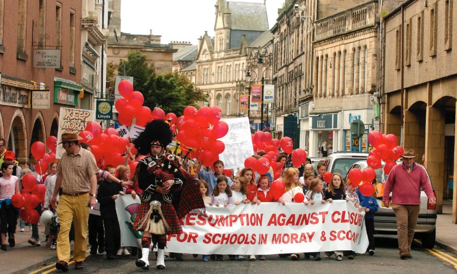 School campaigners march down Elgin High Street. 