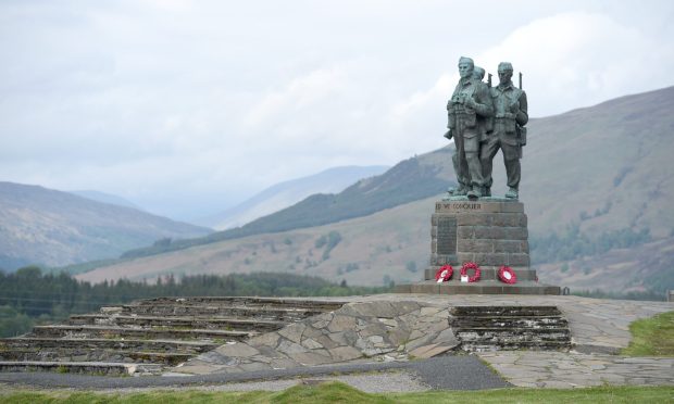 Commando Memorial complete with three male statues on top overlooking the surrounding valley and hills.