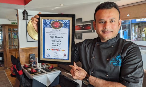 Jabir Hussain with chef award inside Panache Indian restaurant.